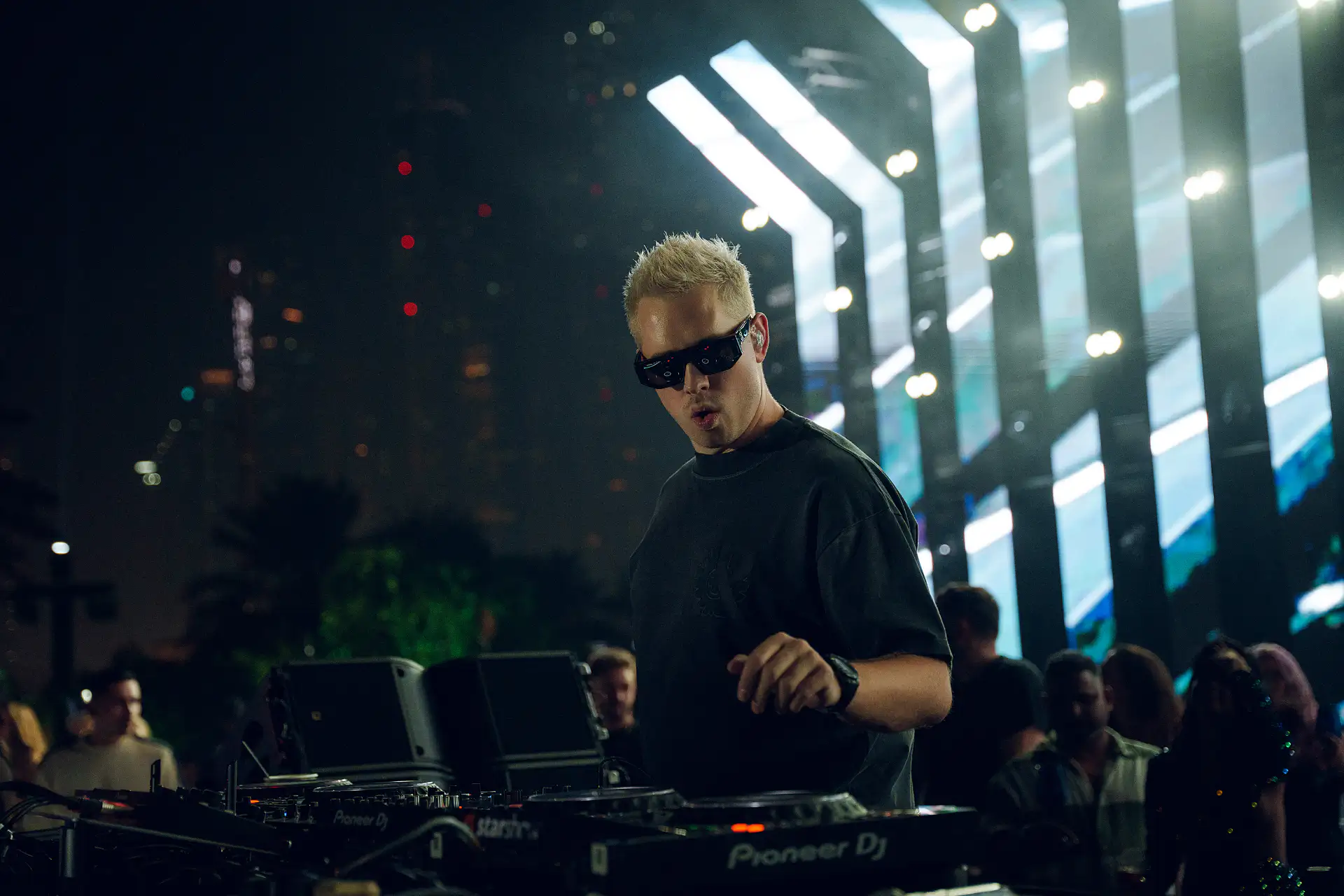 Scott Forshaw rear-facing on stage with smoke and stage lights at a Dubai festival