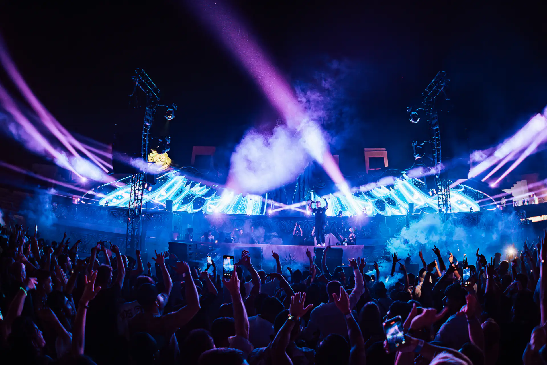 Scott Forshaw mixing live with laser lighting behind him