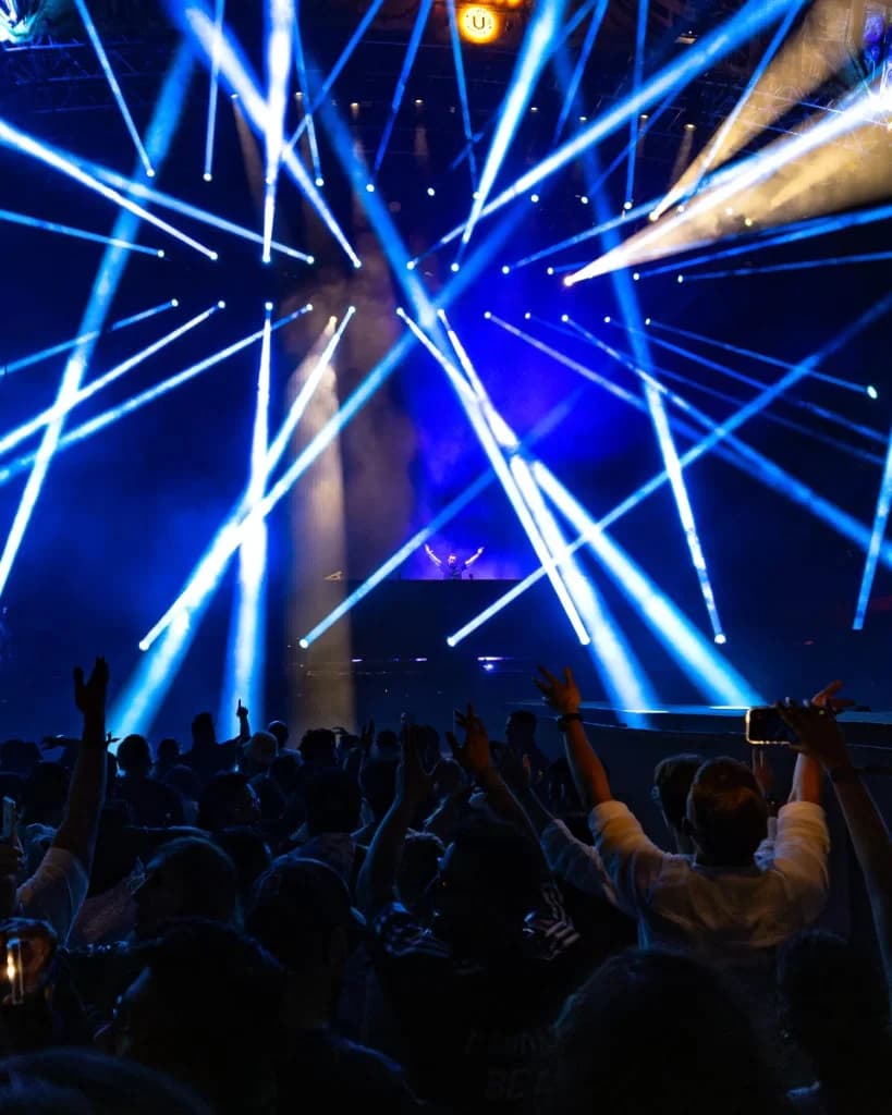Scott Forshaw performing at Ultra Music Festival with blue laser beams and festival crowd